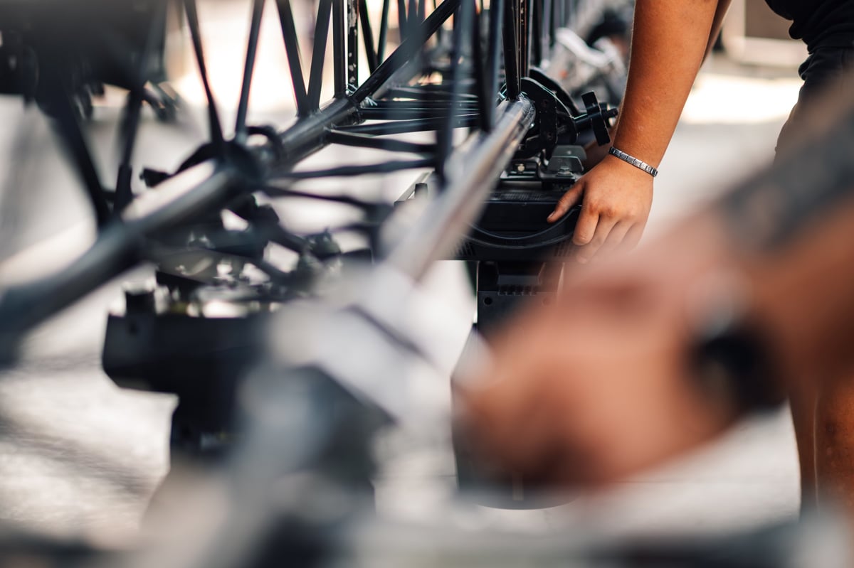 Stage technician assembling truss system